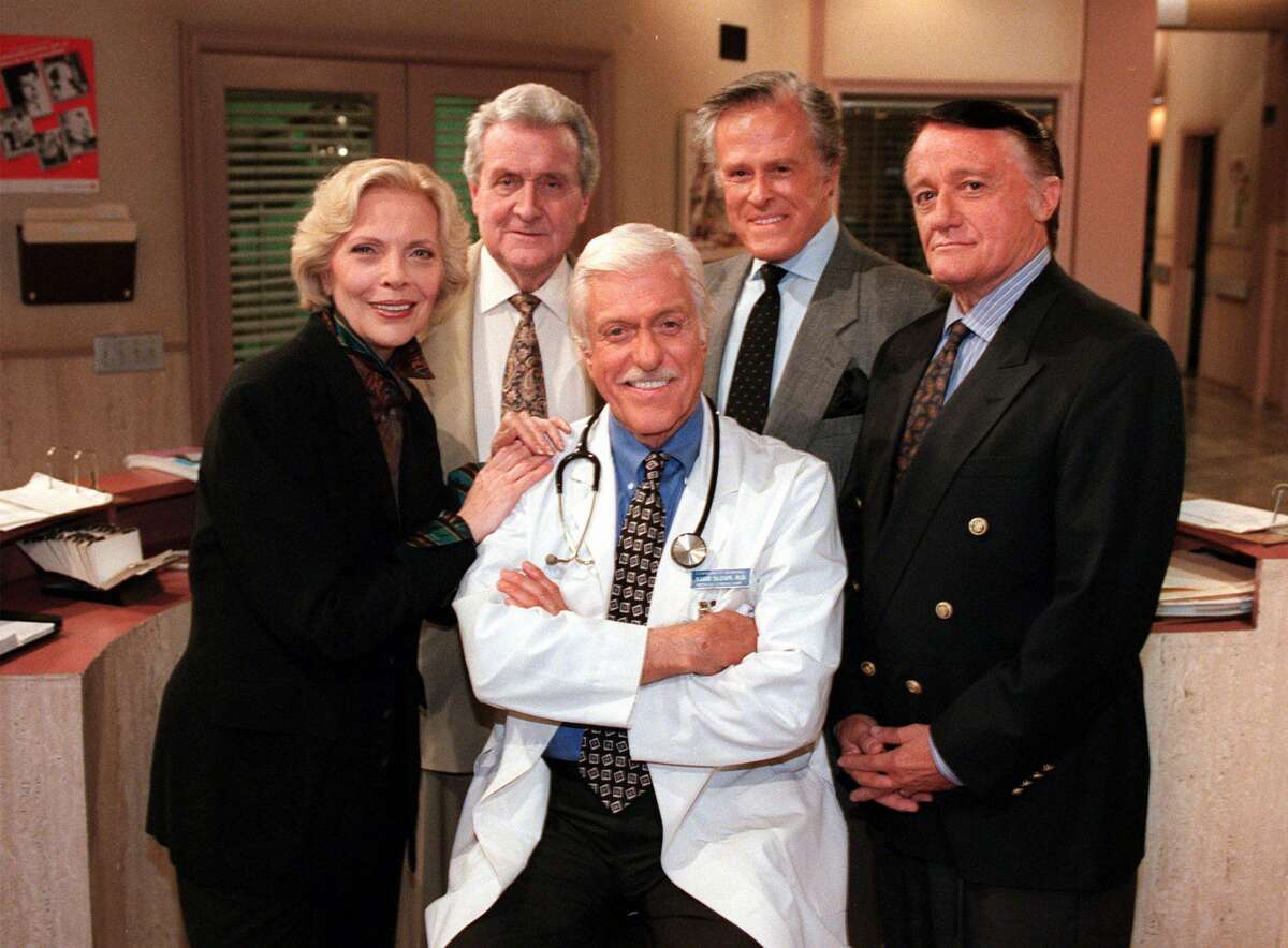FILE - In this Oct. 16, 1997 file photo, Dick Van Dyke, center, poses with his guest stars, from left, Barbara Bain, Patrick Macnee, Robert Culp and Robert Vaughn, on "Diagnosis Murder" during a break on the set of the CBS series in the Van Nuys section of Los Angeles. Macnee, star of the 1960s TV series ìThe Avengers,î has died at age 93. His son Rupert said in a statement that Macnee, died Thursday, June 25, 2015, at his home in Rancho Mirage. (AP Photo/Reed Saxon, File)