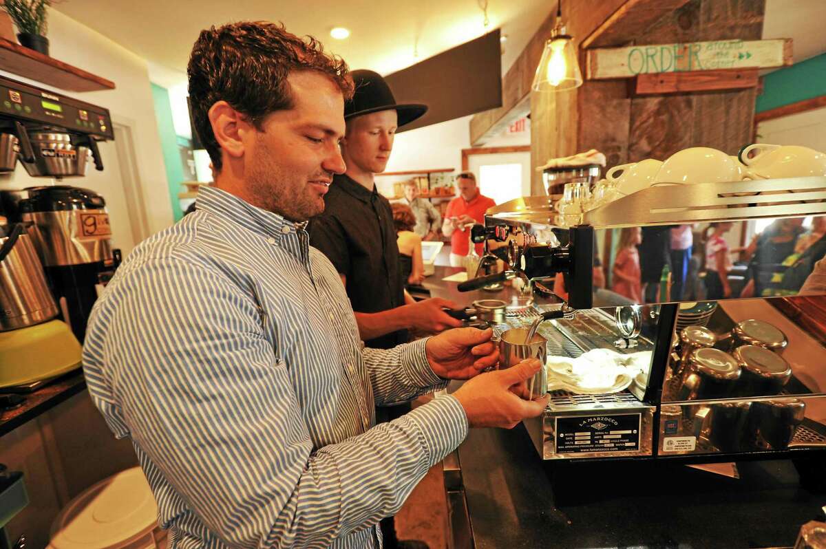 Giv Coffee co-owner Jeff Brooks, and Chris Bugnacki work at the Cappuccino machine at the Giv Coffee Roastery and Cafe in Canton.