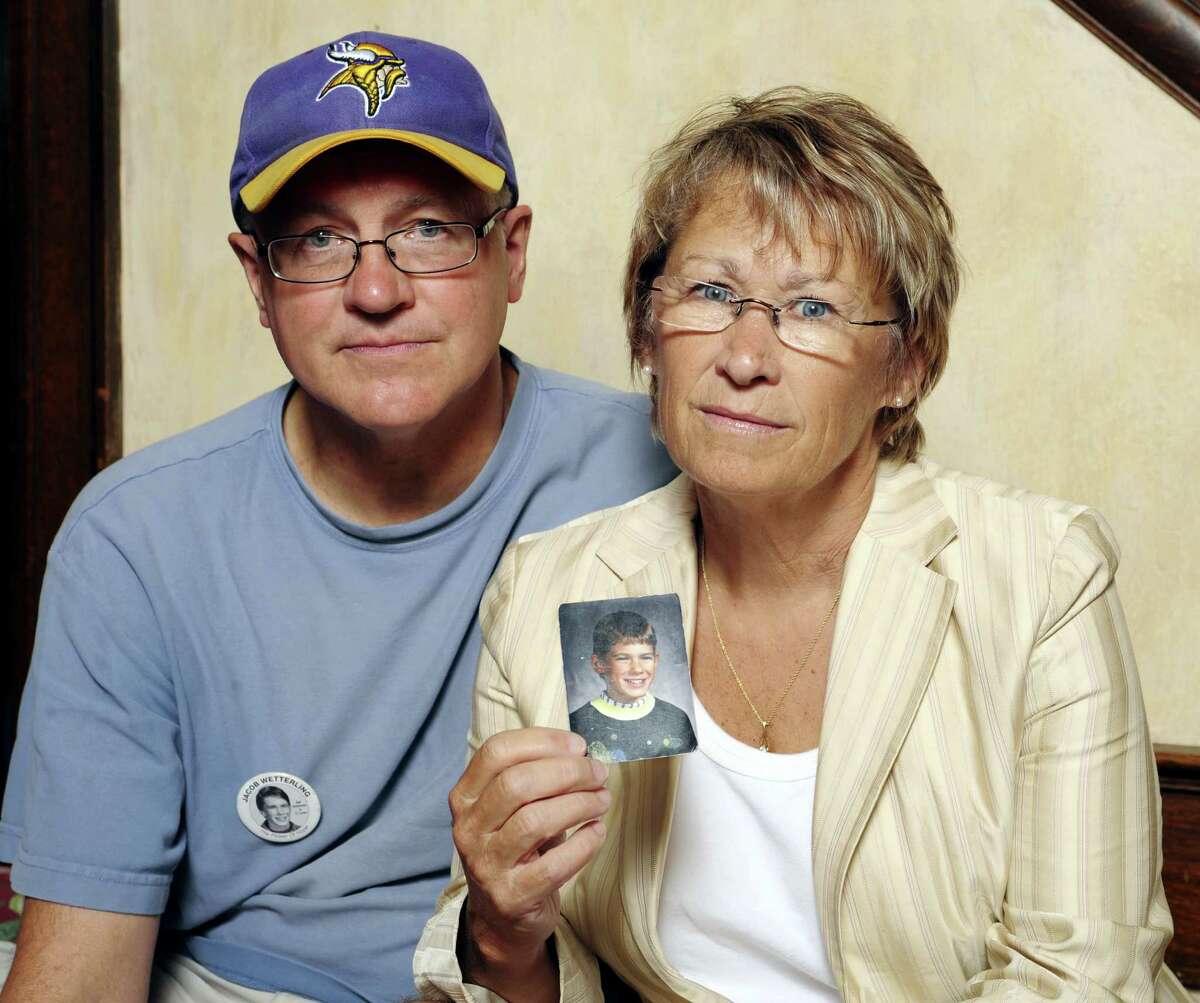 In this Aug. 28, 2009, file photo, Patty and Jerry Wetterling show a photo of their son Jacob Wetterling, who was abducted in October of 1989 in St. Joseph, Minn and is still missing, in Minneapolis. Patty Wetterling said Saturday, Sept. 3, 2016, that his remains have been found. Daniel Heinrich, who authorities have called a person of interest in the 1989 kidnapping, denied any involvement and was not charged with that crime. But he has pleaded not guilty to several federal child pornography charges.