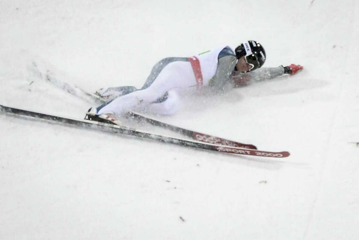 Nicholas Alexander of the U.S crashes during the normal hill HS100 mixed team ski jumping event at the 2015 FIS Nordic Skiing World Championships in Falun, Sweden, Sunday,.