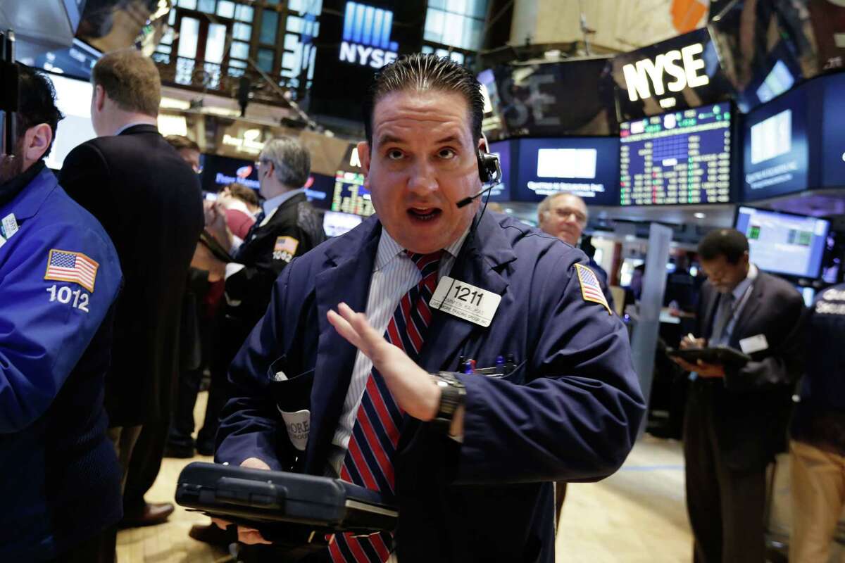 Trader Tommy Kalikas talks on his mobile phone as he works on the floor of the New York Stock Exchange Monday.