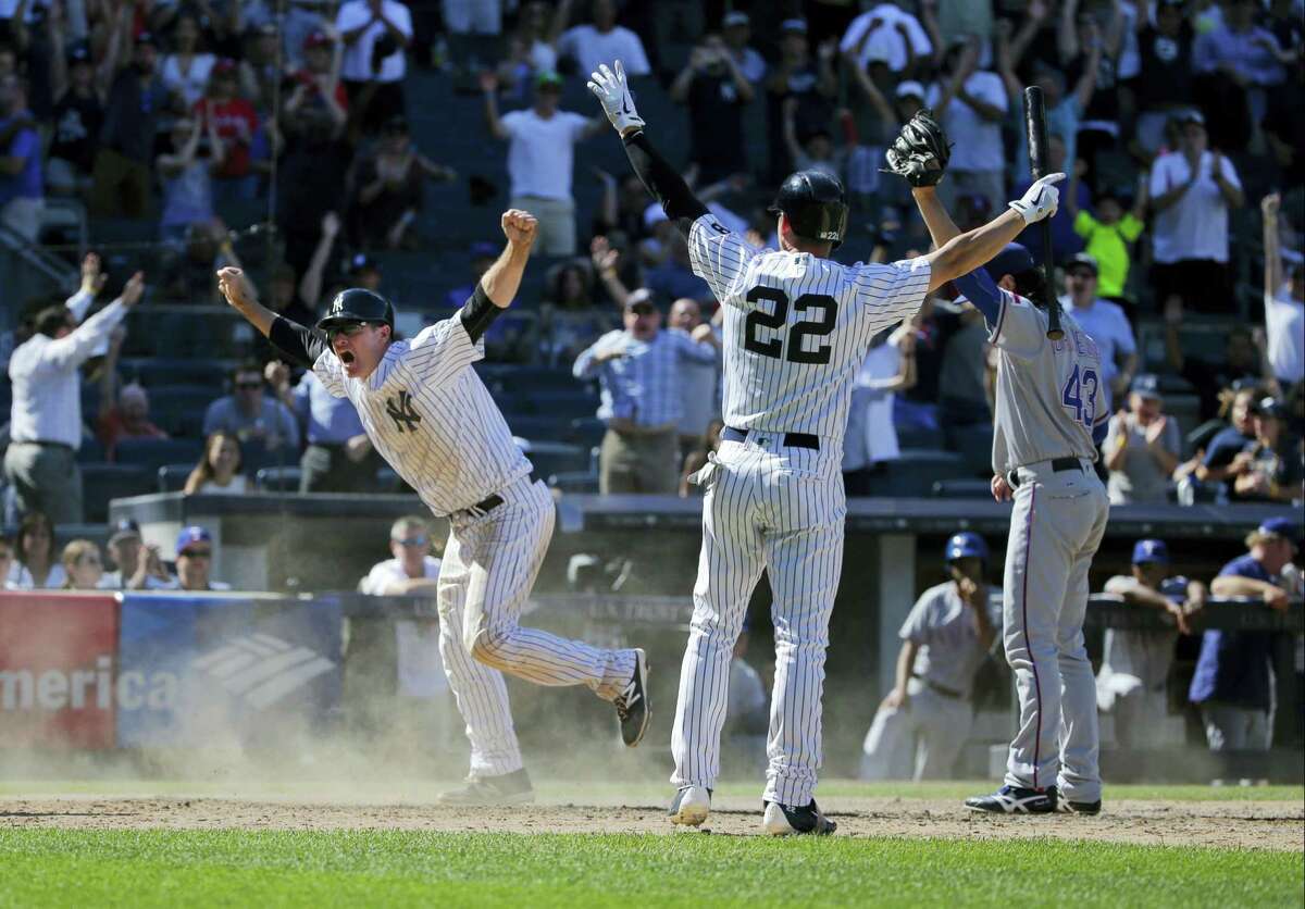 Jacoby Ellsbury (22) celebrates after Chase Headley, left, slid safely into home to score the game winning-run on Thursday.
