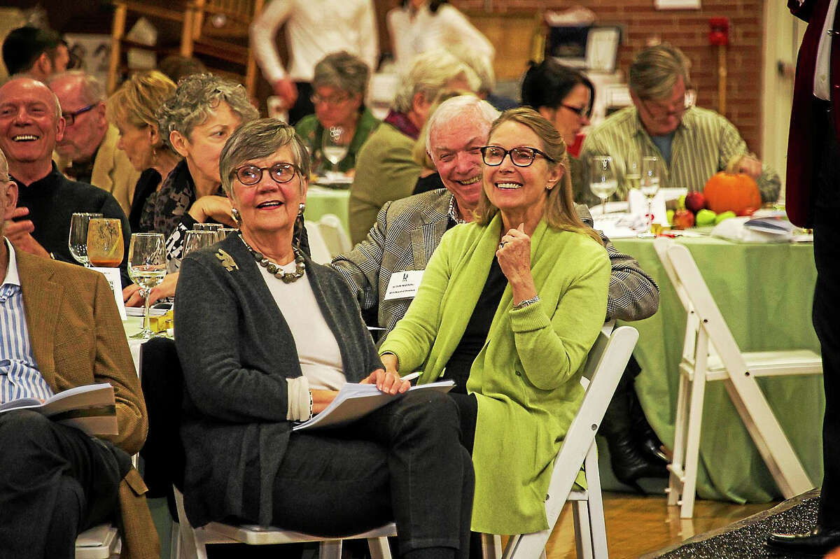 HVA board director Ecton Manning, right, and his wife, Betsy, left, with Marlene Smith, all Washington residents, enjoying the auctioneer’s remarks at last year’s charity event.