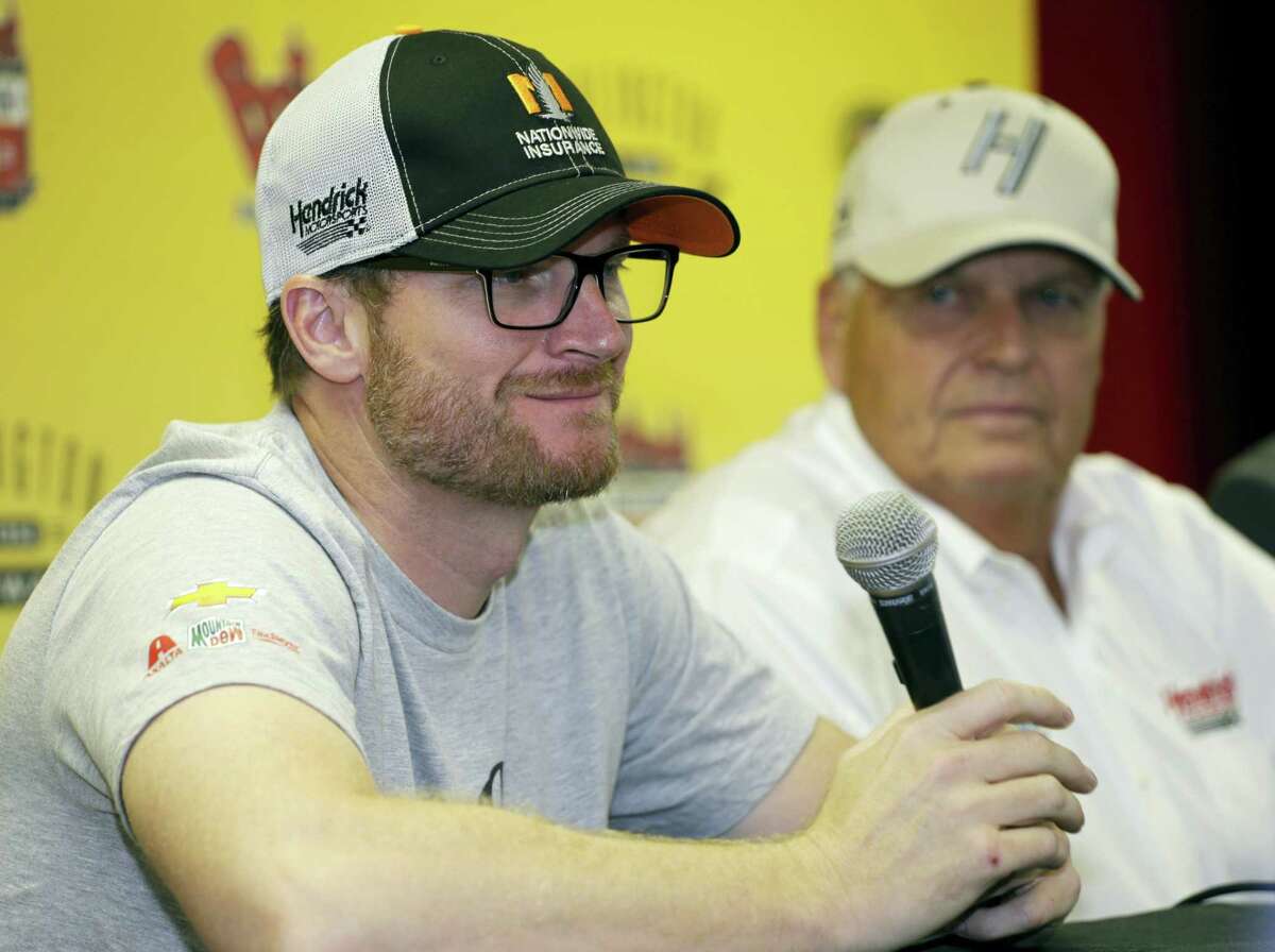 Dale Earnhardt Jr., left, and team owner Rick Hendrick talk to reporters during a news conference Sunday at Darlington Raceway.