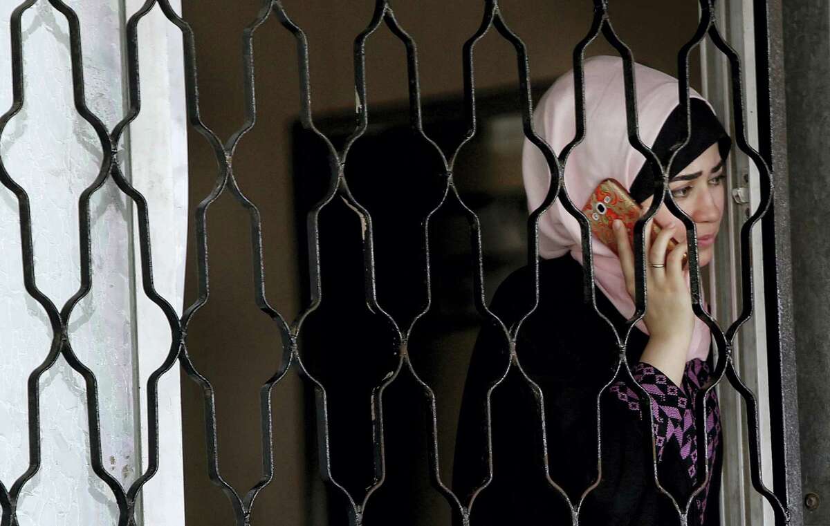 A Palestinian woman talks on her mobile phone as she waits to cross the border to the Egyptian side of Rafah crossing with Egypt, in Khan Younis City, Gaza Strip, Wednesday, June 29, 2016. Hamas says Egypt has temporarily opened its border with the Gaza Strip for five days during the holy month of Ramadan and before the upcoming of Eid al-Fitr. The Rafah border crossing, Gaza’s main gateway to the outside world, will operate Wednesday until Monday.