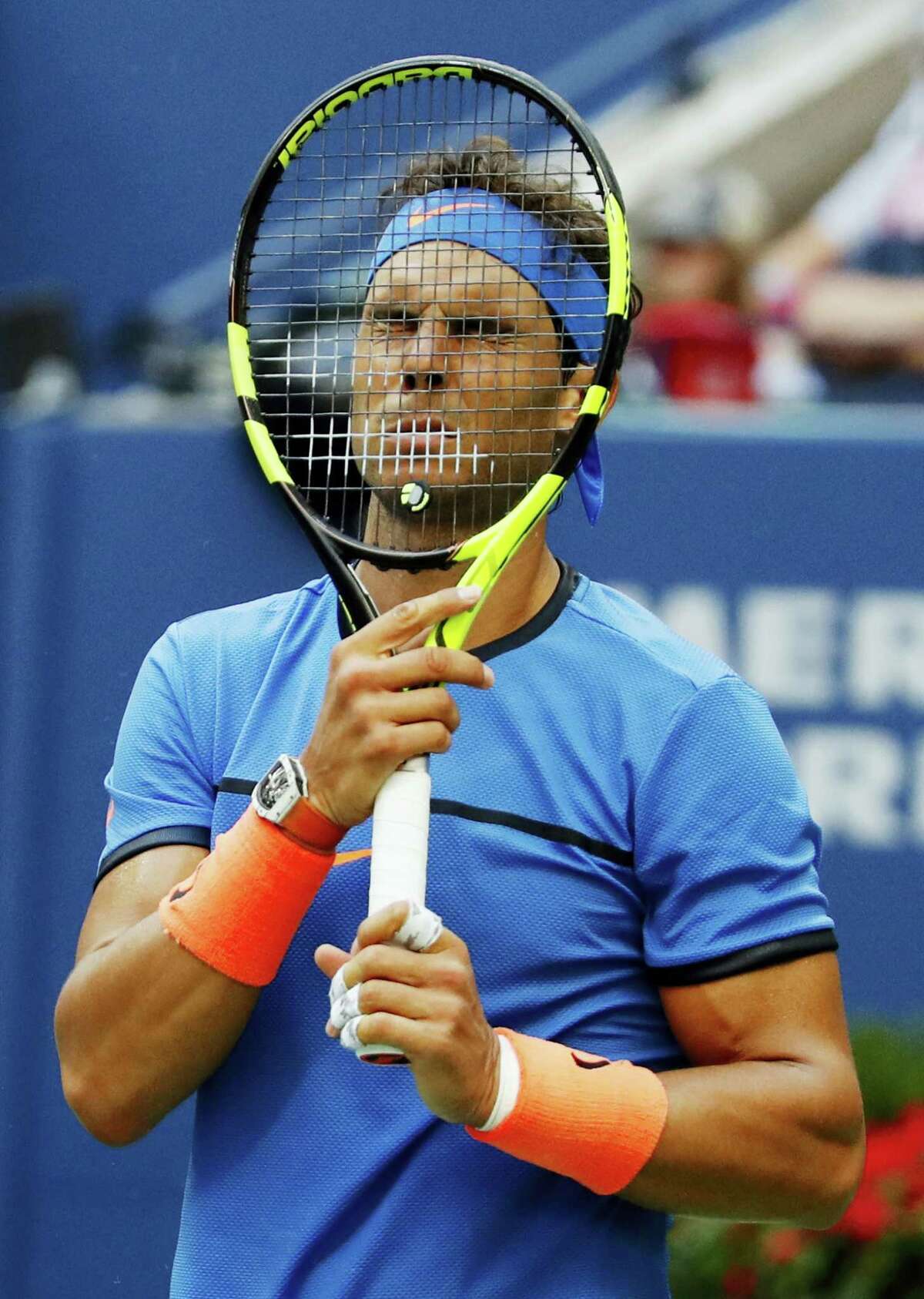 Rafael Nadal puts his racket to his face during his match against Lucas Pouille at the U.S. Open on Sunday.