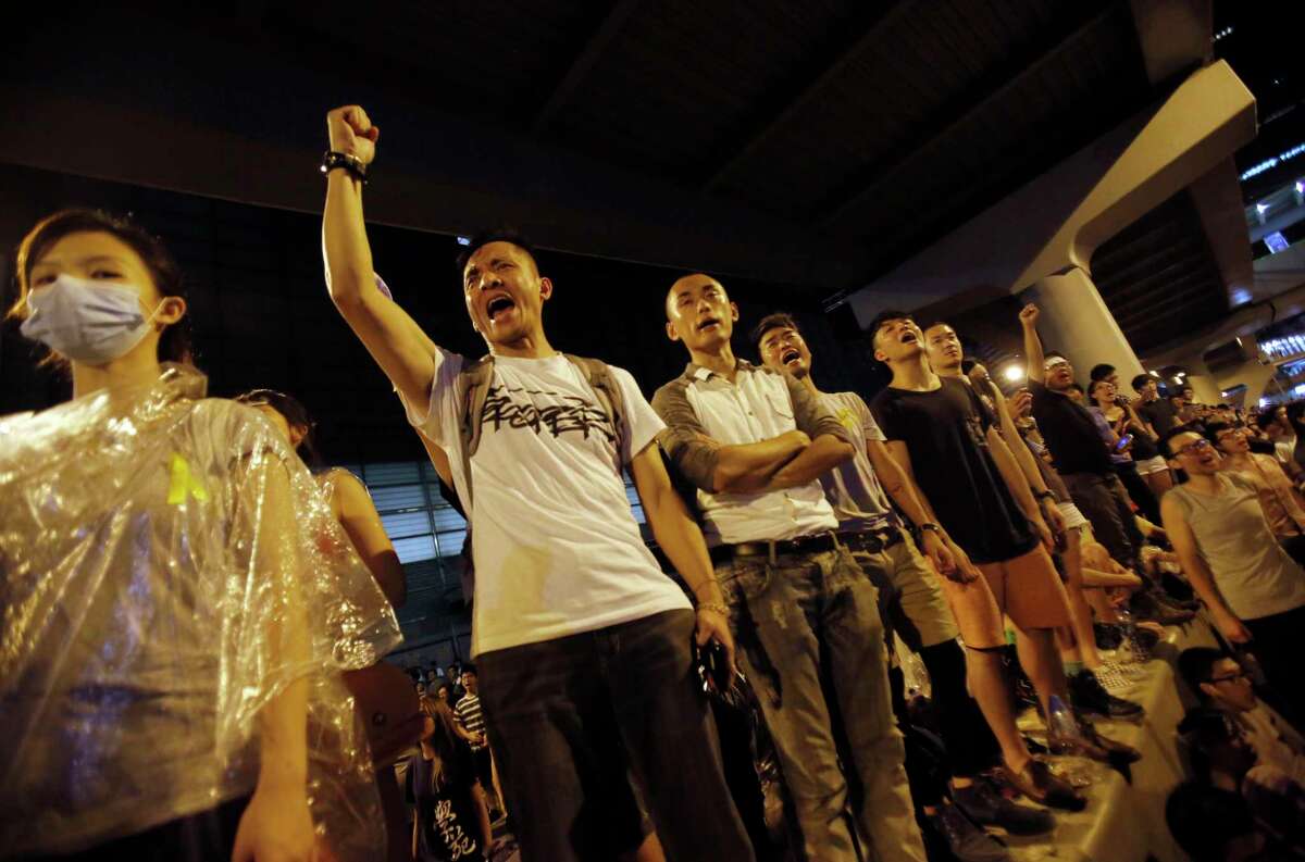 Protesters cheer on the announcement of the official occupation of streets surrounding government headquarters in Hong Kong, China, in this file photo.