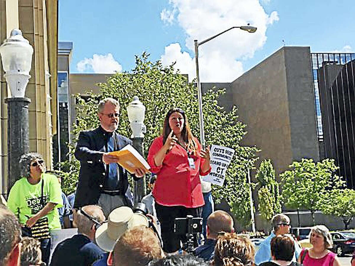 State interpreters James Cusack and Tammy Batch speak Wednesday during a rally outside the state office building at 55 Farmington Ave. in Hartfotrd.
