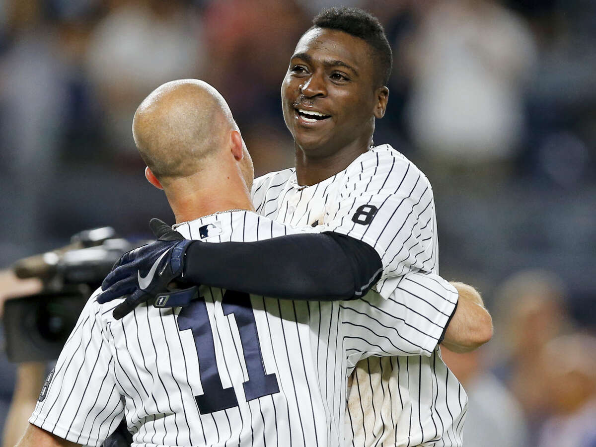 New York Yankees Brett Gardner (11) celebrates with the Didi Gregorius after Gregorius hit a ninth-inning, walk-off, two-run, homer to lift the Yankees to a 9-7 victory over the Texas Rangers in a baseball game in New York Wednesday.