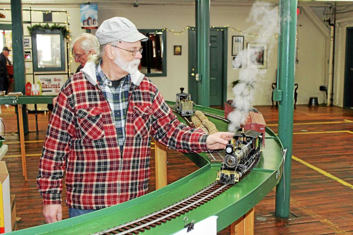 Chester Louis from Granby, Mass., works the track at a train show at Whiting Mills in Winsted on Saturday.