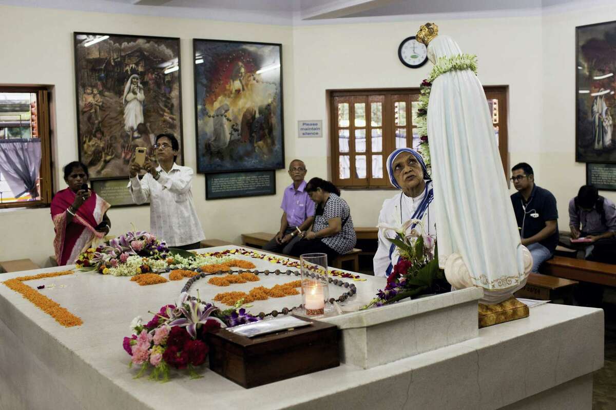 Worshippers gather around the tomb of Mother Teresa inside the Mother house in Kolkata, India, Saturday, Sept. 3, 2016. For many of the poor and destitute whom Mother Teresa served, the tiny nun was a living saint. Many at the Vatican would agree, but the Catholic Church nevertheless has a grueling process to make it official, involving volumes of historical research, the hunt for miracles and teams of experts to weigh the evidence. In Mother Teresa’s case, the process will come to a formal end Sunday when Pope Francis declares the church’s newest saint.