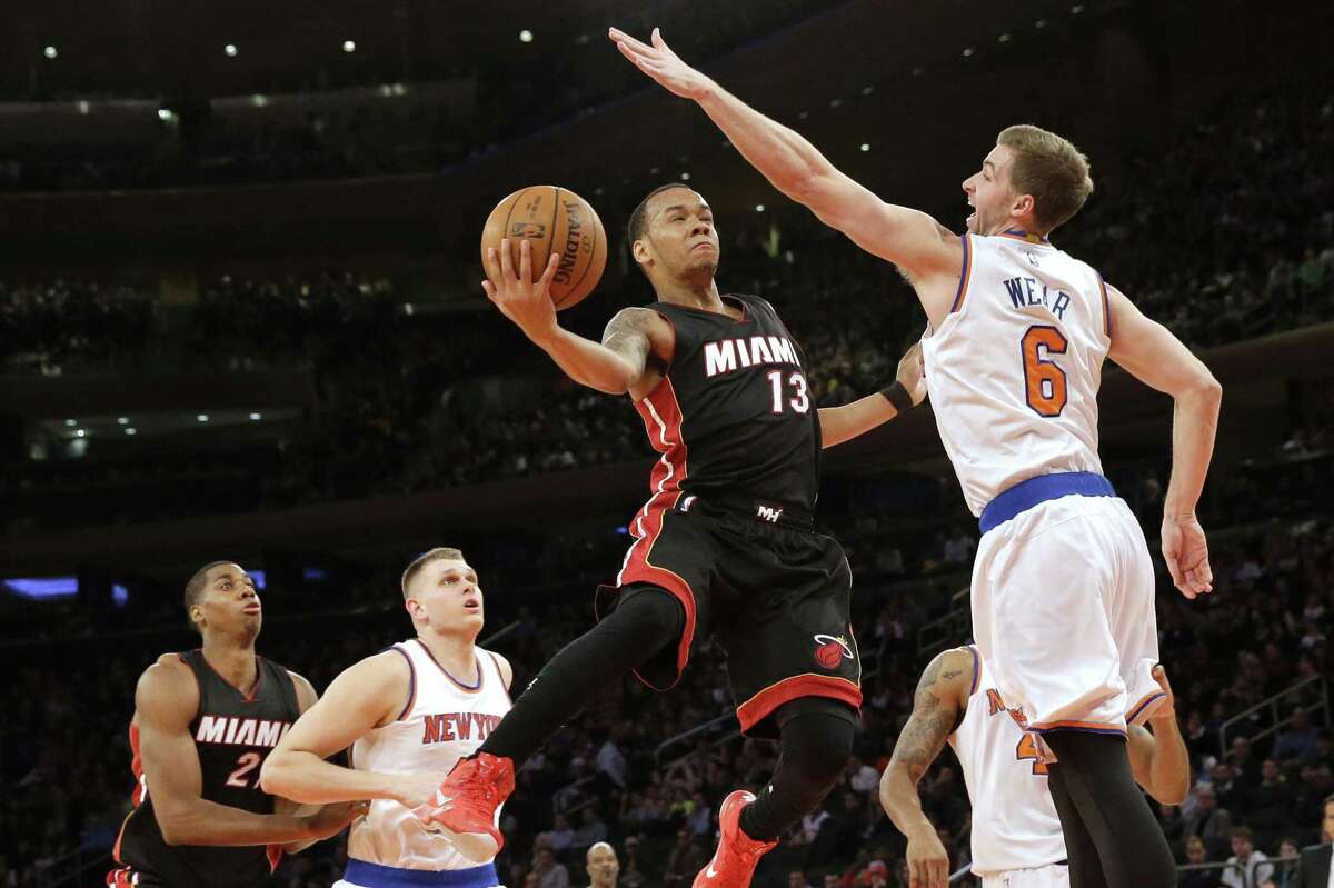 Miami Heat guard Shabazz Napier goes up against Knicks forward Travis Wear during the first half of Friday’s game at Madison Square Garden in New York.