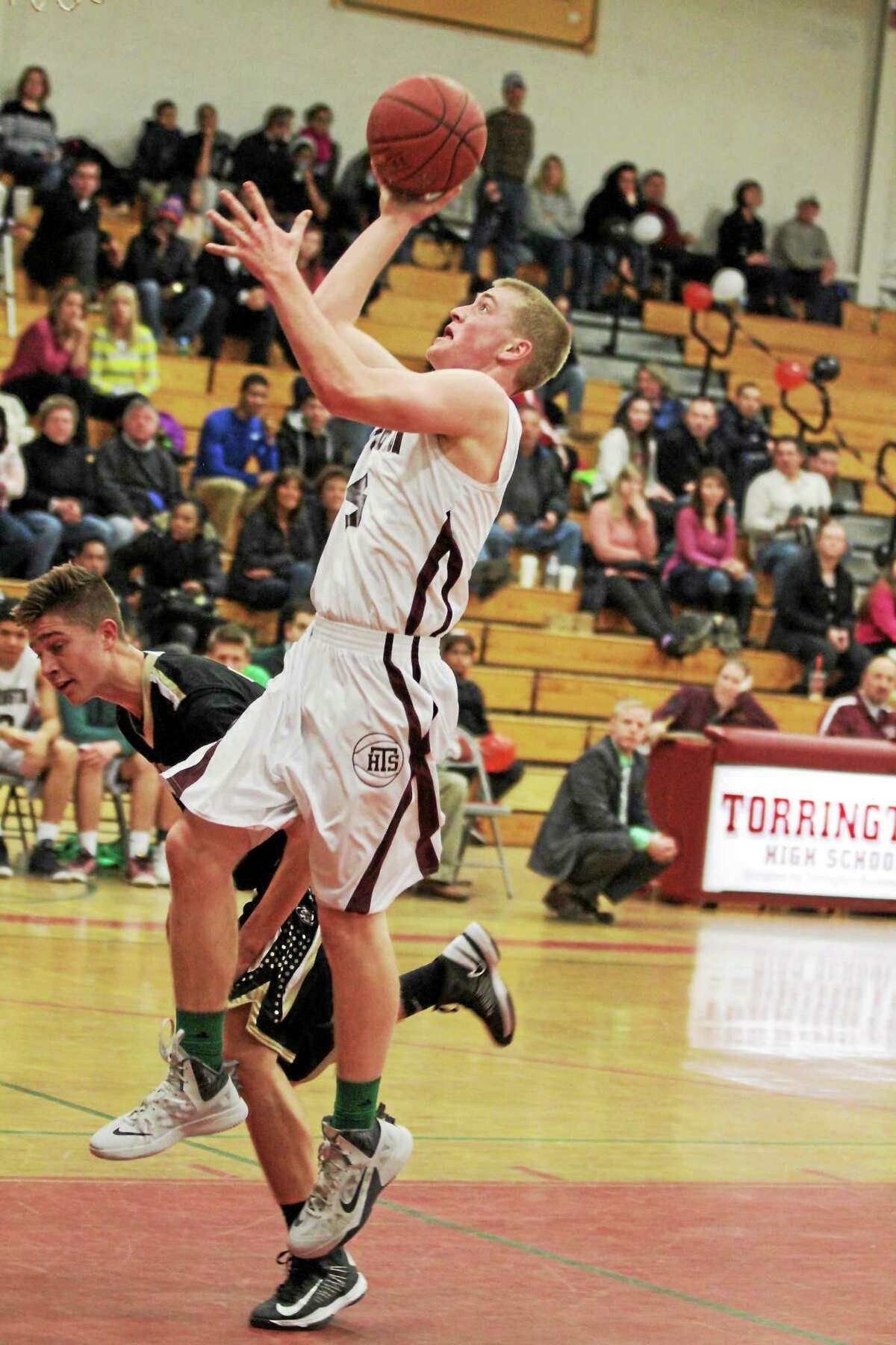 Torrington’s Connor Finn goes up for a layup in his team’s victory over Woodland.