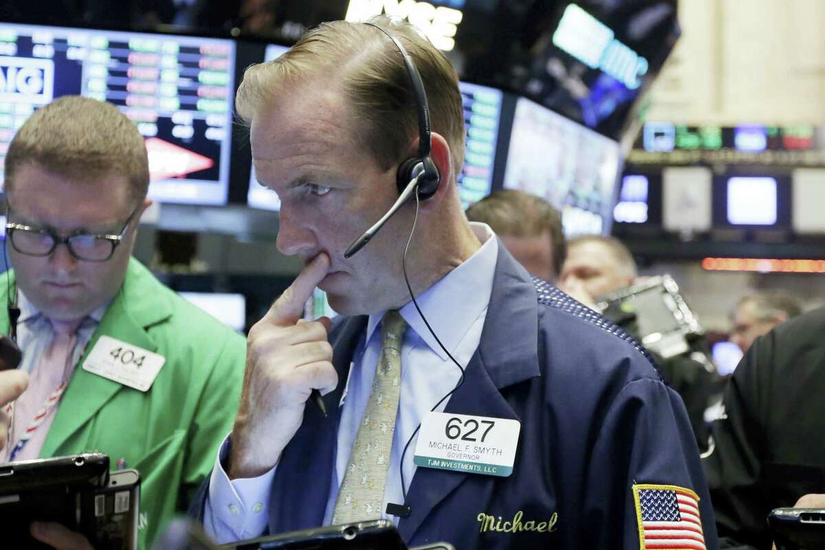 Trader Michael Smyth, center, works on the floor of the New York Stock Exchange Wednesday.
