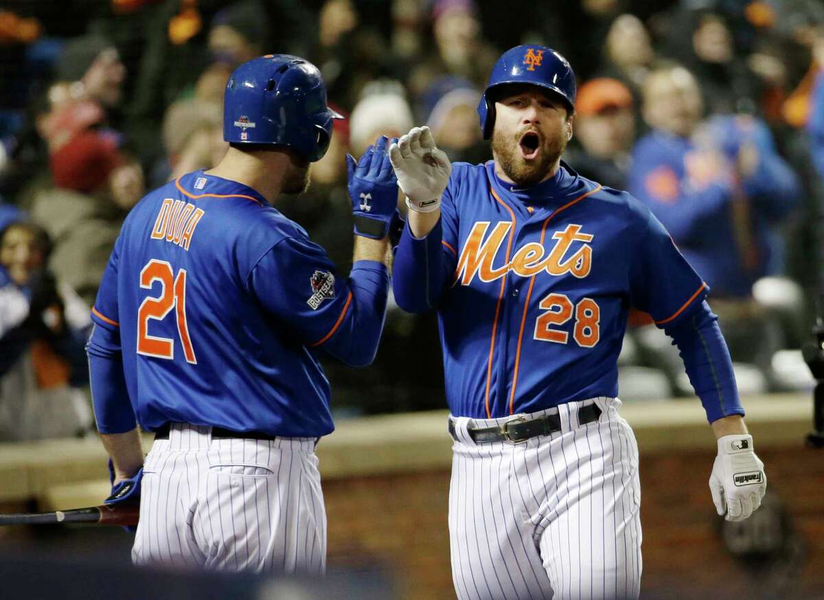 The Mets’ Daniel Murphy is congratulated by teammate Lucas Duda after hitting a two-run home run in the first inning Sunday.