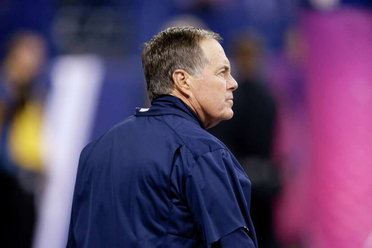 Patriots head coach Bill Belichick watches his team warm up before Sunday’s game against the Colts.