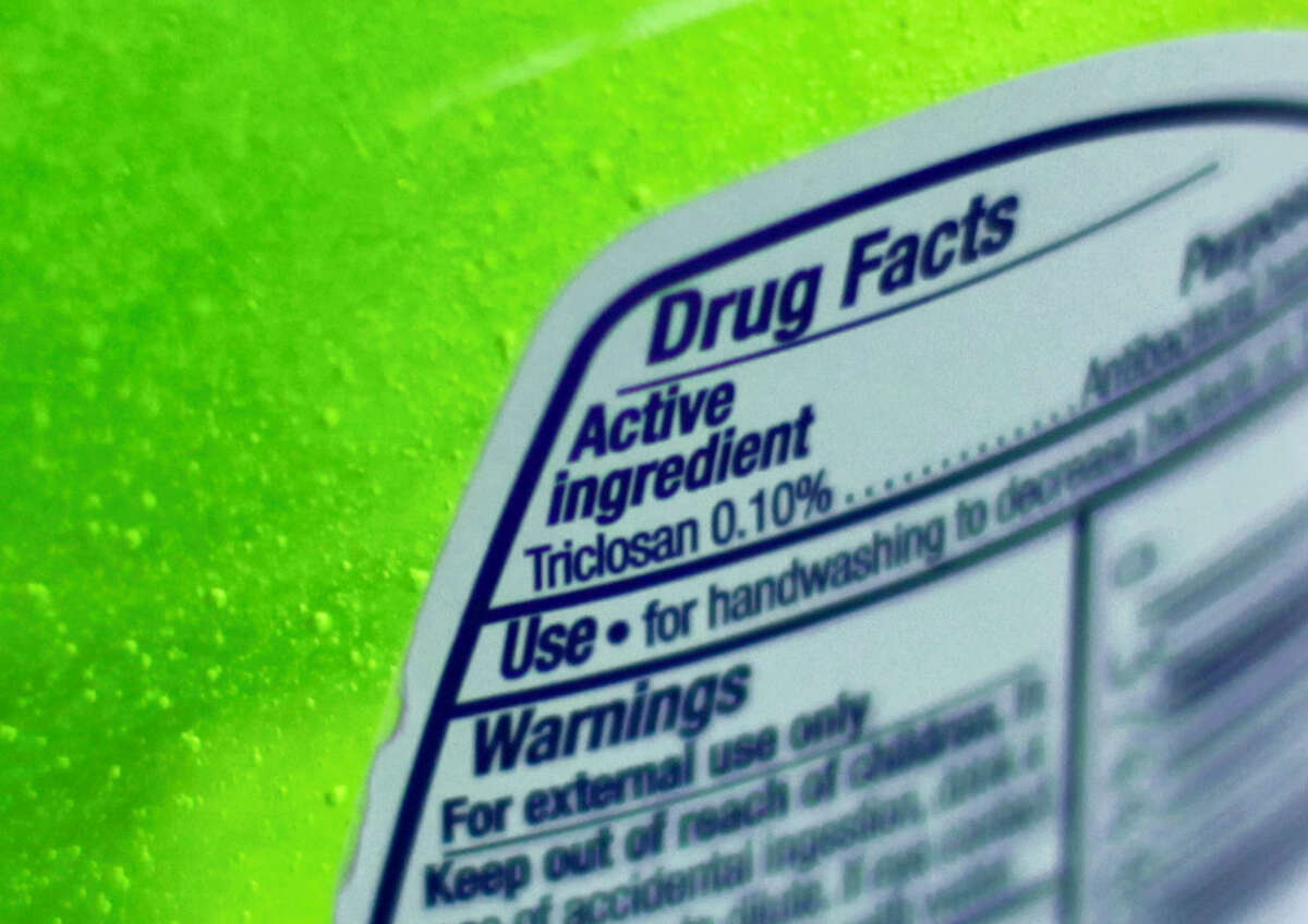 This Tuesday, April 30, 2013, file photo shows the label of a bottle of antibacterial soap in a kitchen in Chicago. The U.S. government is banning more than a dozen chemicals, including triclosan, long-used in antibacterial soaps and washes, saying manufacturers have failed to show that they are safe and prevent the spread of germs.