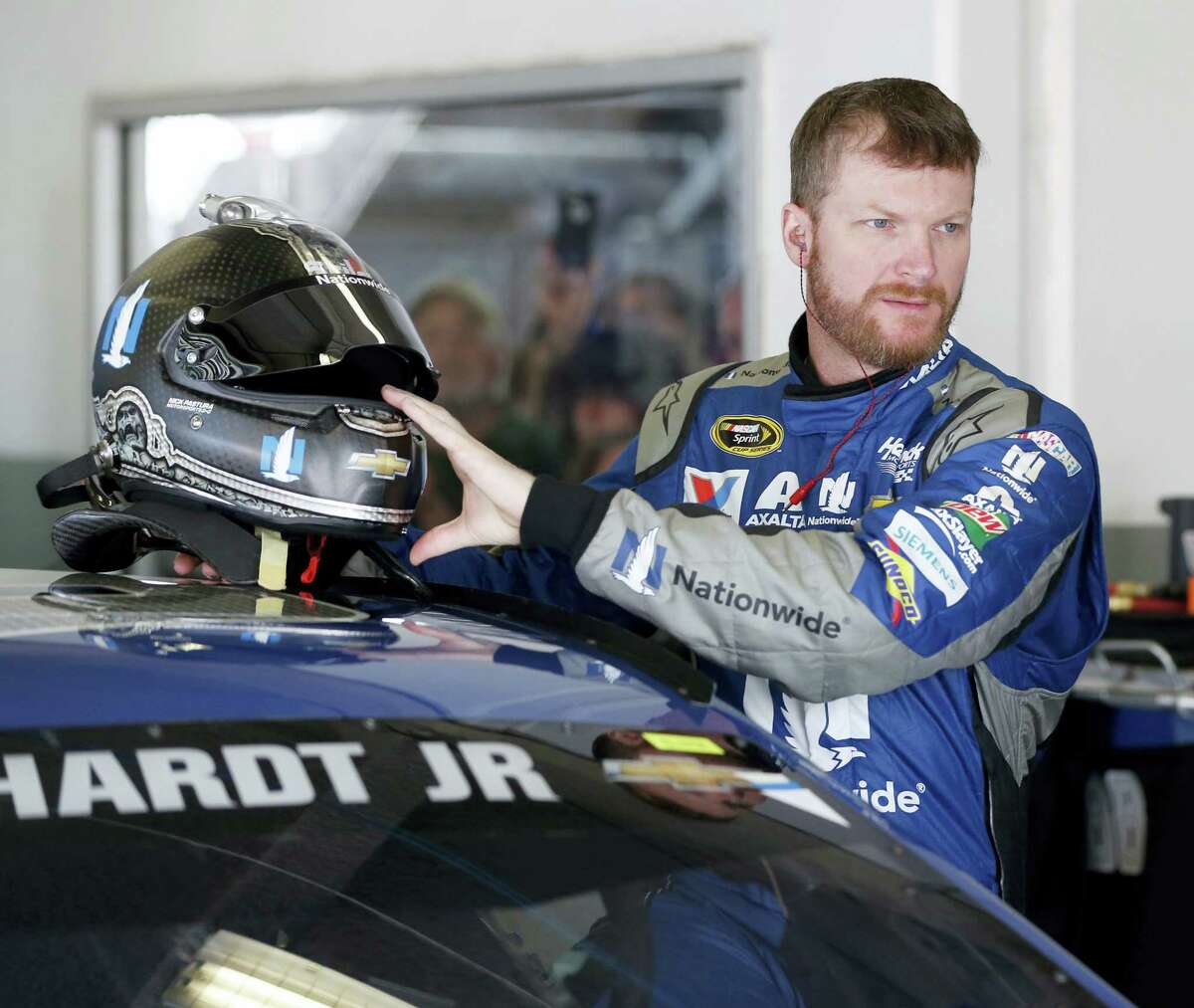 Dale Earnhardt Jr prepares to climb into his car during practice on Friday for Sunday’s Daytona 500.