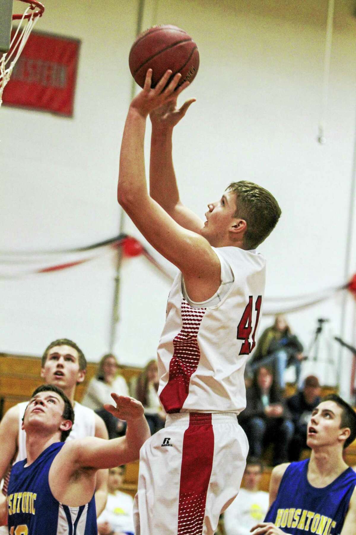 Wamogo sophomore Garrett Coe soars above the crowd for two of his 14 points against Housatonic Friday night.