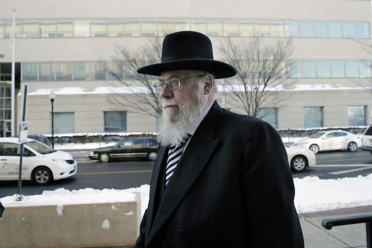 Rabbi Mendel Epstein, right, arrives for his trial at federal court in Trenton, N.J. on Wednesday, Feb. 18, 2015. Prosecutors say Epstein employed a kidnap team to force unwilling Jewish husbands to divorce their wives. (AP Photo/Mel Evans)