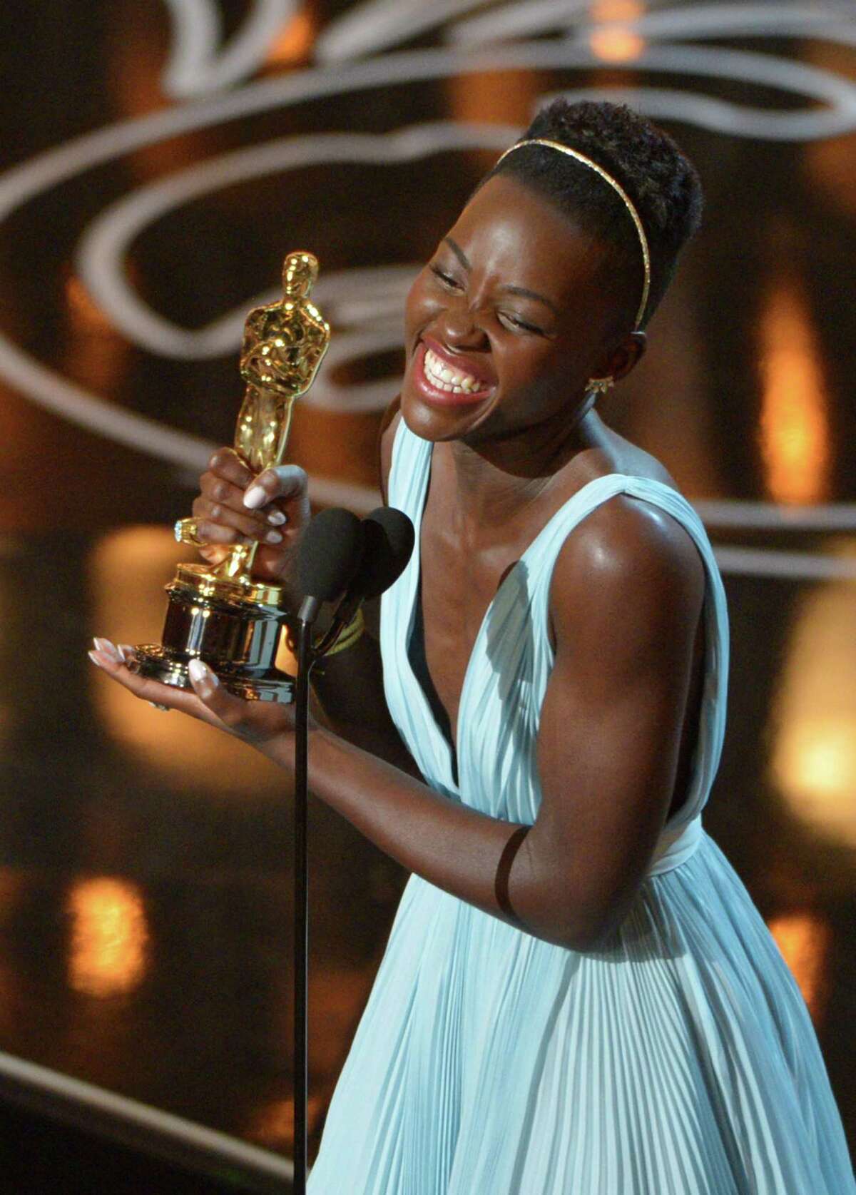 FILE - In this March 2, 2014 file photo, Lupita Nyongío accepts the award for best actress in a supporting role for "12 Years a Slave" during the Oscars in Los Angeles. Nyongío dazzled Hollywood and the Oscar-viewing public through awards season last year. The Mexican-born, Kenyan-raised actress was a central part last year to an Academy Awards flush with faces uncommon to the Oscar podium. There was Ellen DeGeneres, a proud lesbian, hosting. There was the first Latino, Alfonso Cuaron, winning best director. There was the black filmmaker Steve McQueen hopping for joy after his ì12 Years a Slaveî won best picture. (Photo by John Shearer/Invision/AP, File)