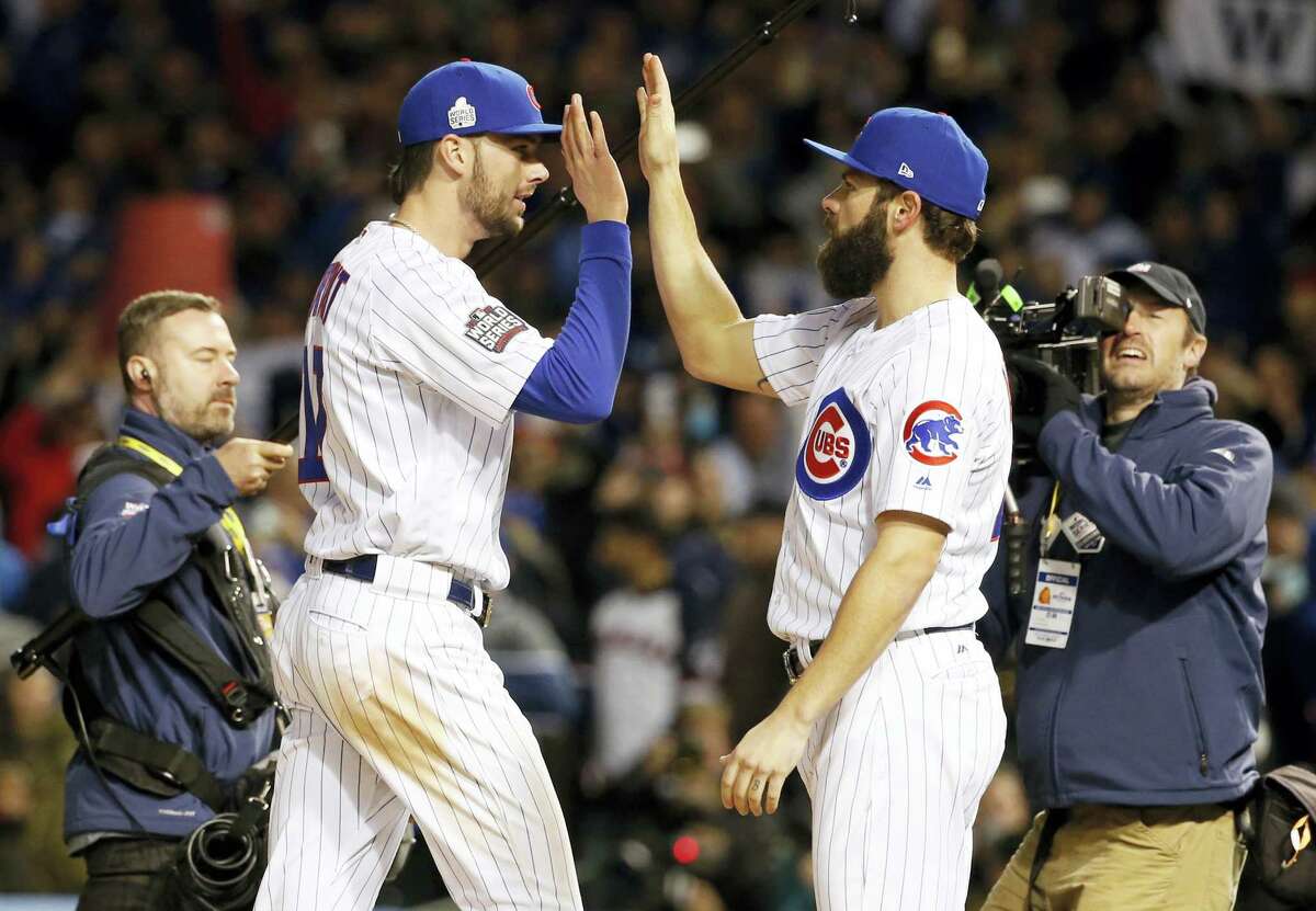 Chicago Cubs’ Kris Bryant, left, celebrates with Jake Arrieta after Game 5 of the Major League Baseball World Series against the Cleveland Indians on Oct. 30, 2016 in Chicago. The Cubs won 3-2 as the Indians lead the series 3-2.