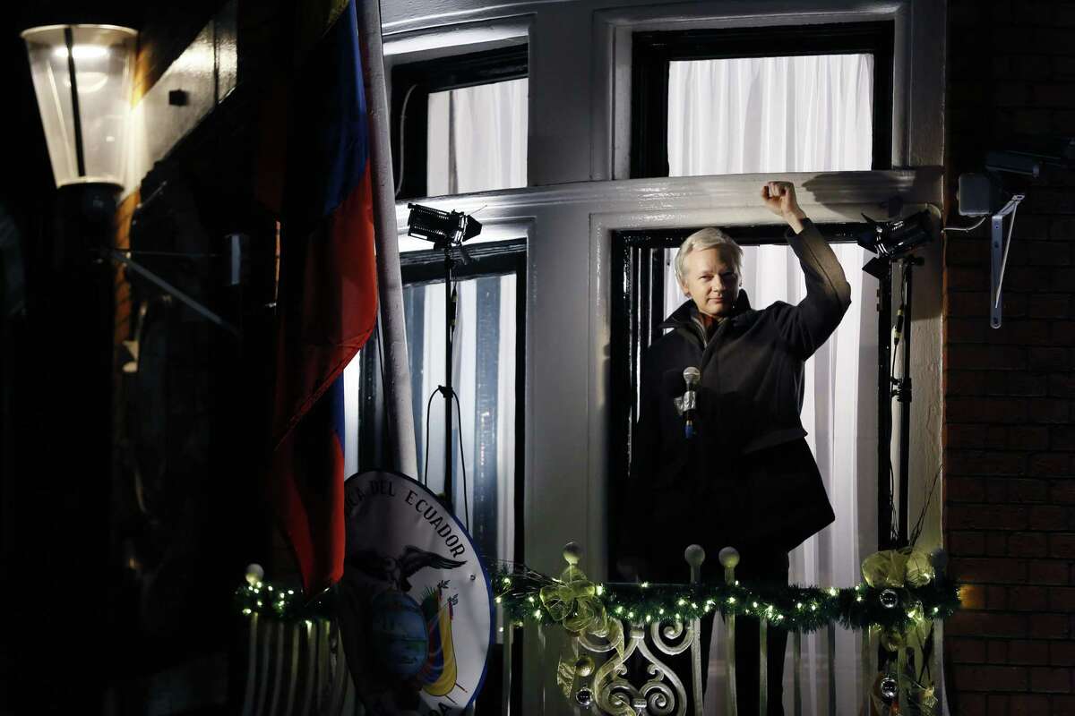 FILE - In this Thursday, Dec. 20, 2012 file photo, Julian Assange, founder of WikiLeaks gestures as he speaks to the media and members of the public from a balcony at the Ecuadorian Embassy in London, Thursday, Dec. 20, 2012. Julian Assange is marking the third anniversary of his stay inside Ecuador's London embassy. The WikiLeaks founder entered the building on June 19, 2012, to avoid extradition to Sweden for questioning about alleged sexual assaults. (AP Photo/Kirsty Wigglesworth, File)