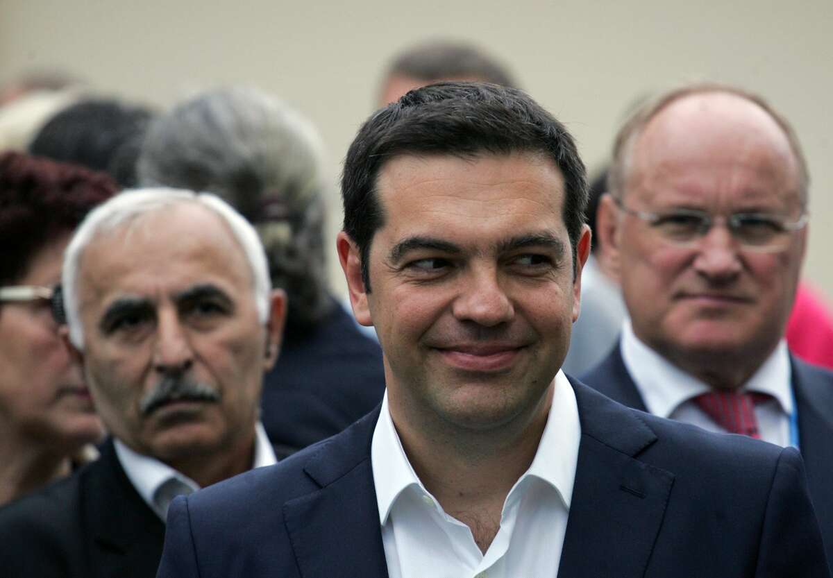 Greek Prime Minister Alexis Tsipras smiles while taking part in a wreath laying ceremony, at the monument for the founder of modern Greek state Ioannis Kapodistrias, in St. Petersburg, Russia, Friday. Russia is willing to consider giving financial aid to Greece, President Vladimir Putin’s spokesman said Friday ahead of talks between the leaders of the two countries.