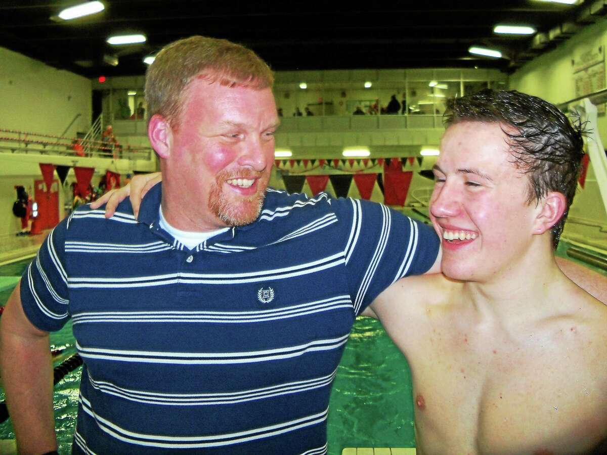 Peter Wallace - Register Citizen Former Shepaug coach Todd Dyer congratulates Northwestern's Peter Kamianowski for breaking Dyer's 28-year-old pool record in the 100-meter butterfly.