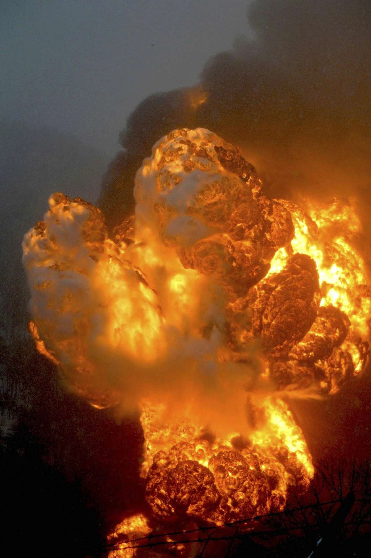 A fire burns Monday, Feb. 16, 2015, after a train derailment near Charleston, W.Va. Nearby residents were told to evacuate as state emergency response and environmental officials headed to the scene. (AP Photo/The Register-Herald, Steve Keenan)