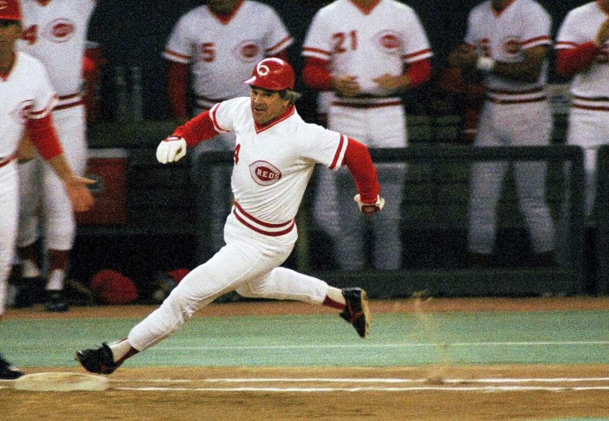 In this Sept. 11, 1985photo, Cincinnati Reds’ Pete Rose rounds first base after hitting a single to break Ty Cobbs’ hitting record during a baseball game at Riverfront Stadium in Cincinnati.
