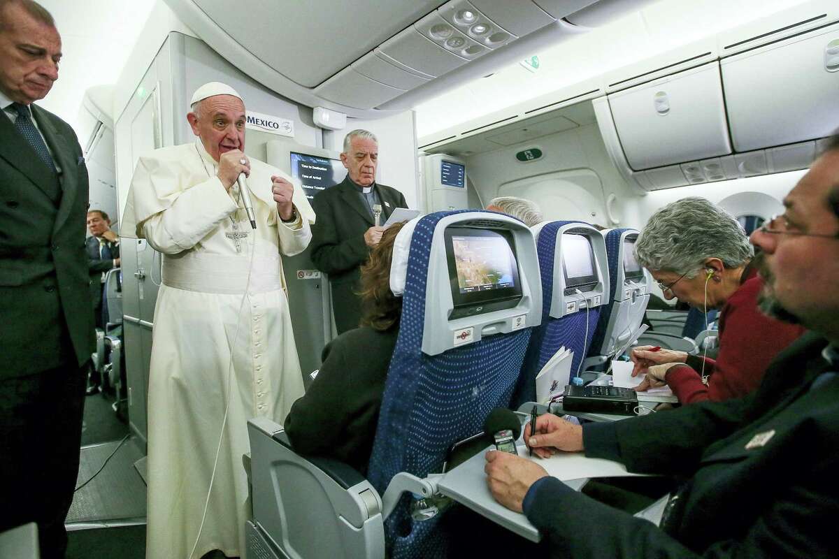 In this photo taken Feb. 17, 2016 Pope Francis meets journalists aboard the plane during the flight from Ciudad Juarez, Mexico to Rome, Italy. The pope has suggested that women threatened with the Zika virus could use artificial contraception but not abort their fetus, saying there’s a clear moral difference between aborting a fetus and preventing a pregnancy.