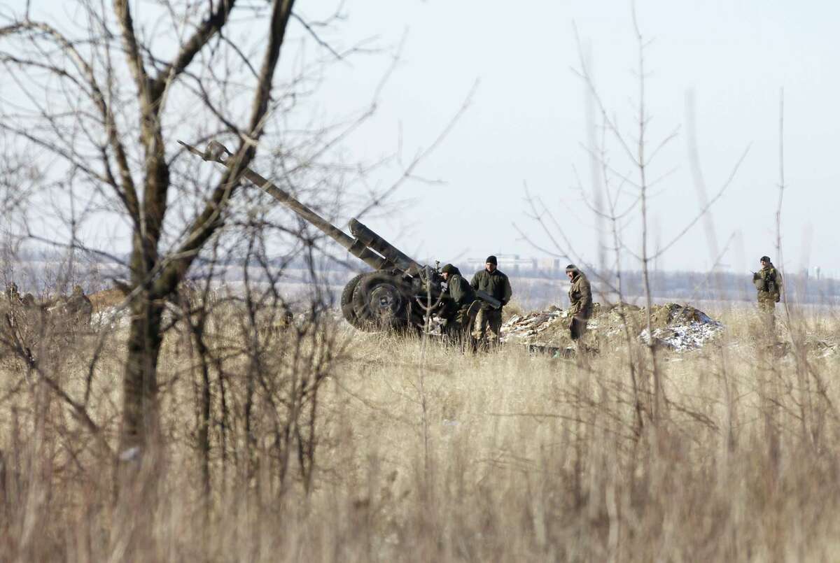 Ukrainian artillery is at a position outside of the village of Luhanske, some 20 kilometers (14 miles) north of Debaltseve, Ukraine, Tuesday, Feb. 17, 2015. Ukrainian government troops and Russia-backed rebels failed Tuesday to start pulling back heavy weaponry from the front line in eastern Ukraine as a deadline passed to do so. Under a cease-fire agreement negotiated by the leaders of Ukraine, Russia, Germany and France last week, the warring sides were to begin withdrawing heavy weapons from the front line on Tuesday. (AP Photo/Petr David Josek)