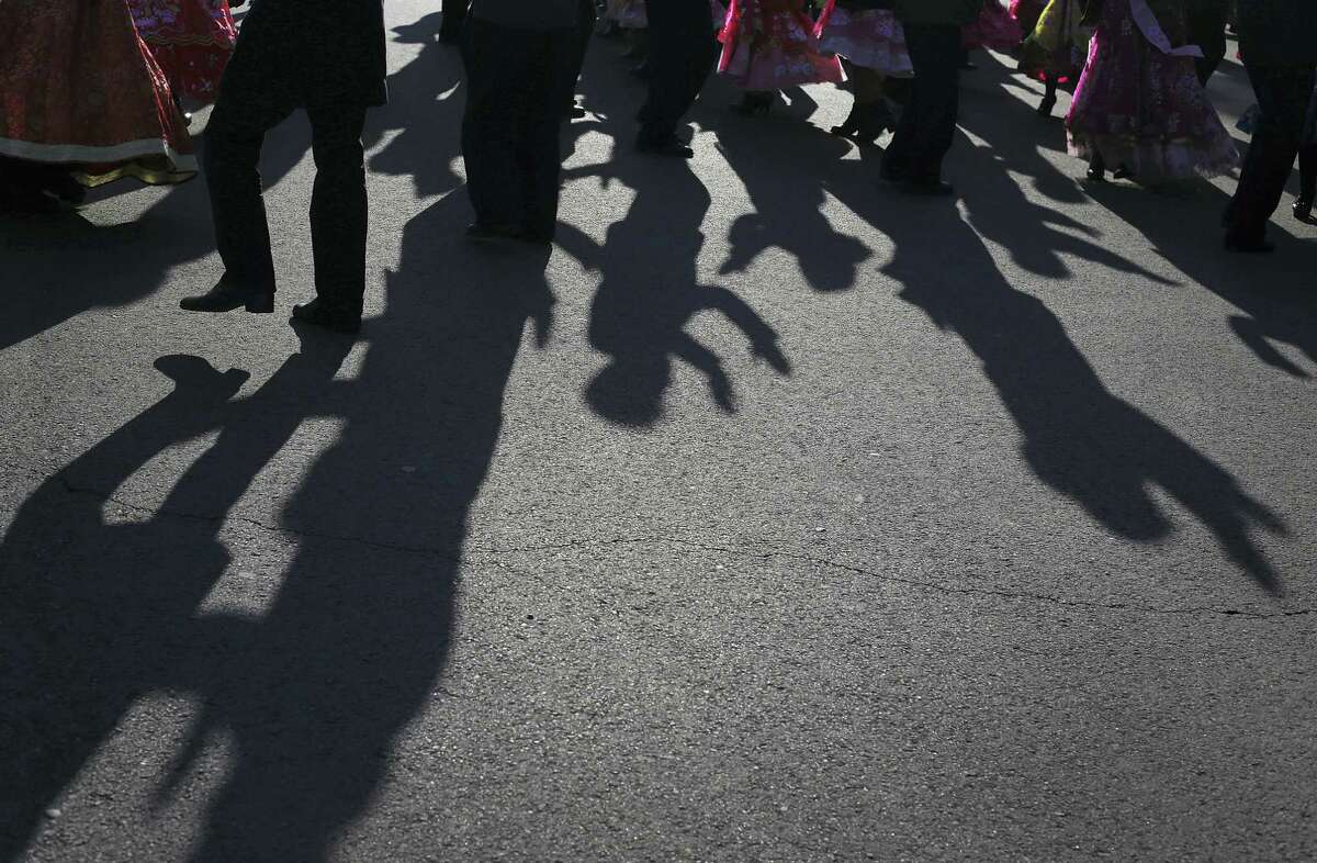 The shadows of North Korean men and women are cast on the grounds of the Pyongyang Indoor Stadium as they participate in a mass dance party as part of celebrations of the “Day of the Shining Star” or birthday anniversary of late North Korean leader Kim Jong Il on Tuesday, Feb. 16, 2016, in Pyongyang, North Korea. The celebrations of the Kim’s birthday anniversary, a revered national holiday, came as South Korea’s president warned that North Korea faces collapse if it doesn’t abandon its nuclear weapons program, amid an international outcry over Pyongyang’s January nuclear test and the Feb. 7 rocket launch.
