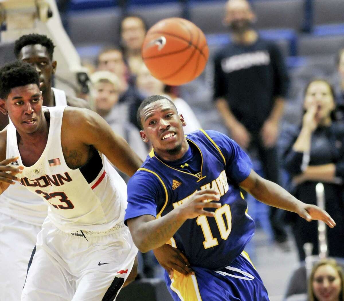 UConn’s Juwan Durham (23) chases a rebound with New Haven’s Danny Upchurch during the second half on Sunday.