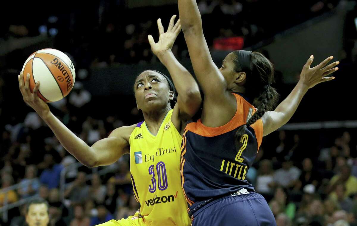 Sparks forward Nneka Ogwumike, left, shoots over Sun forward Camille Little during the second half on Sunday.