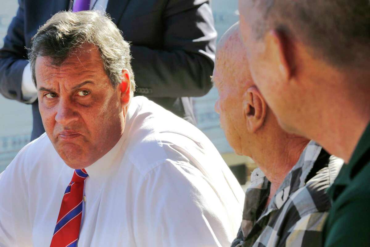 In this Oct. 7, 2015, photo, Republican presidential candidate Gov. Chris Christie, R-N.J., talks with employees during a campaign stop at East Coast Lumber in East Hampstead, N.H. Despite single-digit poll numbers, New Hampshire Republicans tell Chris Christie: Keep going.