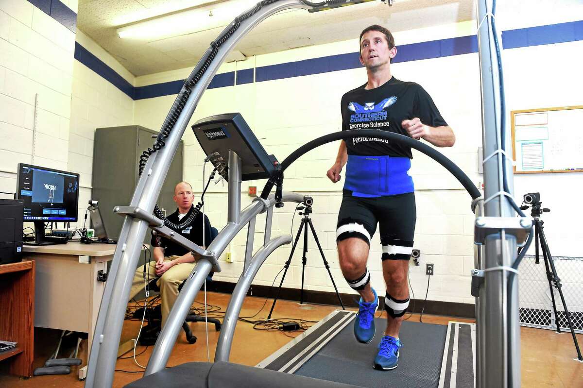 Robert Gregory, left, observes William Lunn on an instrumented treadmill in the Human Performance Laboratory at Southern Connecticut State’s Moore Field House. Both men are assistant professors of exercise science. The treadmill is used to analyze walking and running mechanics for injury prevention.