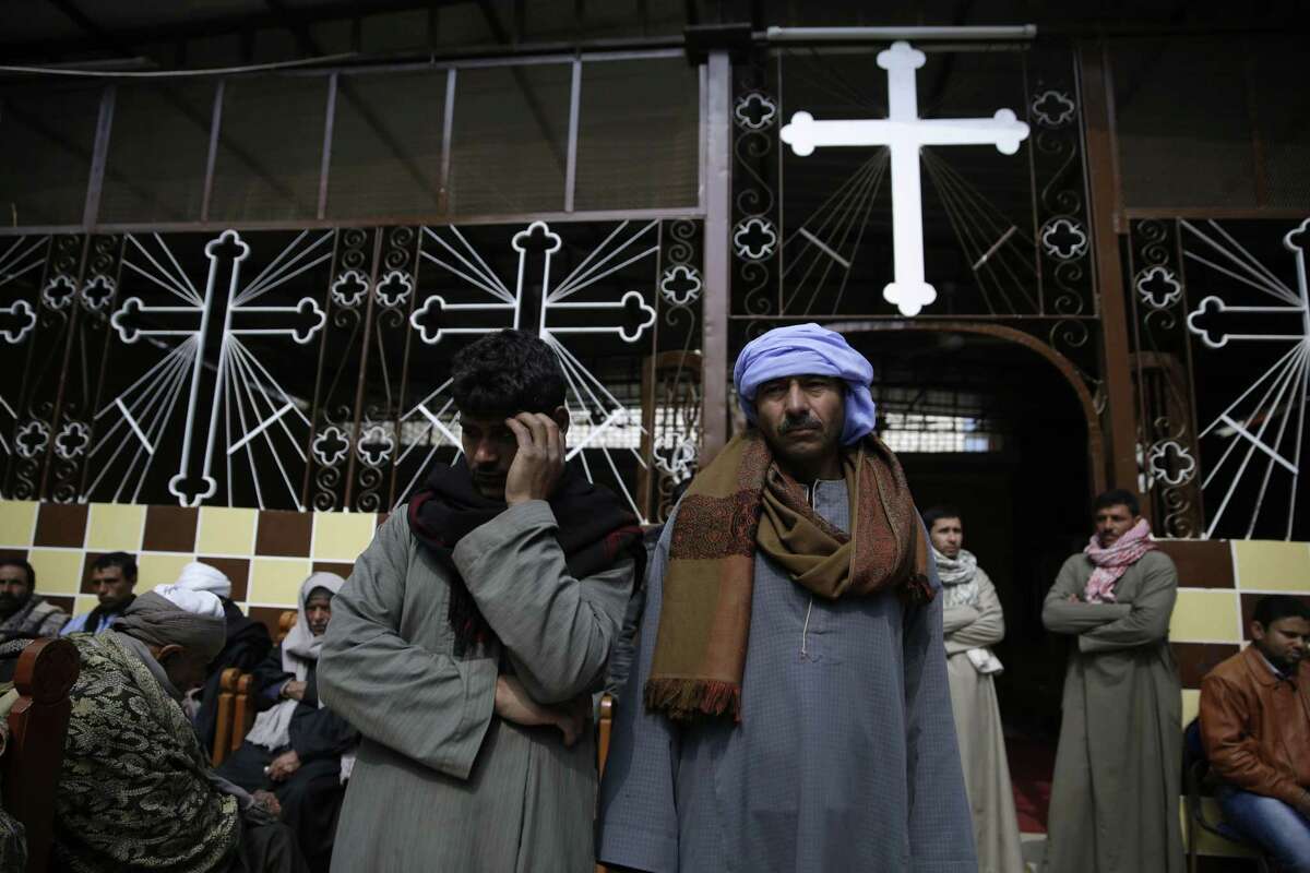Men mourn over the Egyptian Coptic Christians who were captured in Libya and killed by militants affiliated with the Islamic State group, at the Virgin Mary church in the village of el-Aour, near Minya, 220 kilometers (135 miles) south of Cairo, Egypt, Monday, Feb. 16, 2015. Egyptian warplanes struck Islamic State targets in Libya on Monday in swift retribution for the extremists’ beheading of a group of Egyptian Christian hostages on a beach, shown in a grisly online video released hours earlier.