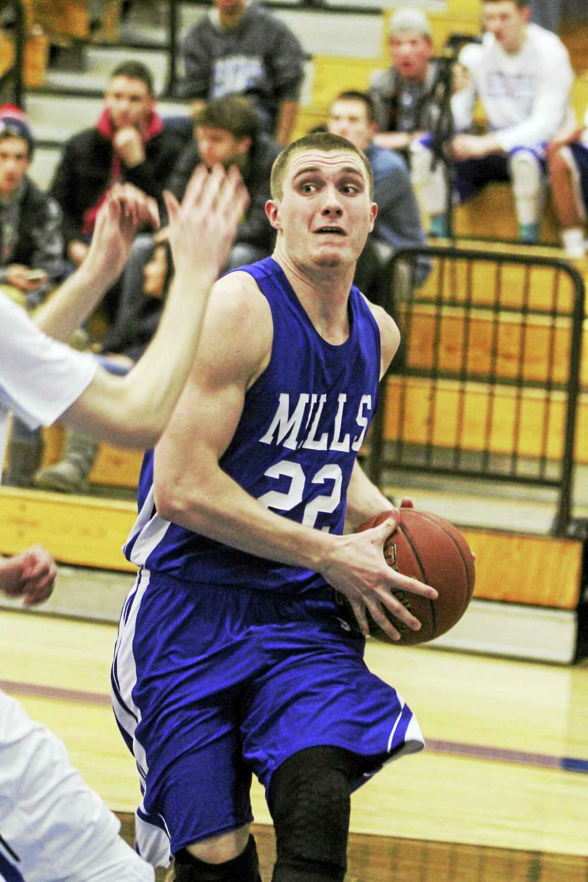 Lewis Mills’ Trevor Baker makes a move in the Spartans’ win over Litchfield on Wednesday.