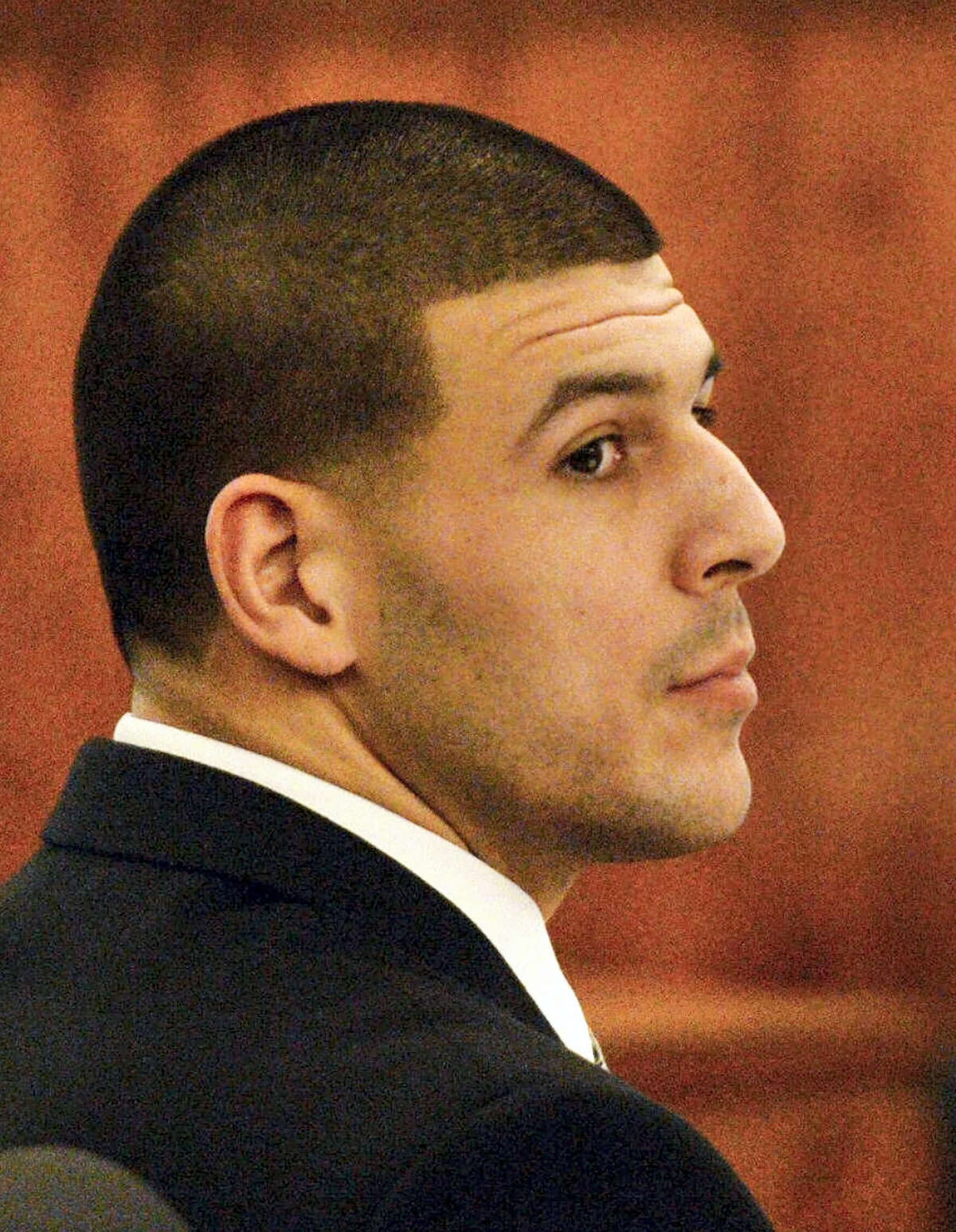In this file photo, former New England Patriots football player Aaron Hernandez listens to testimony during his murder trial, Friday, Jan. 30, 2015, in Fall River, Mass.