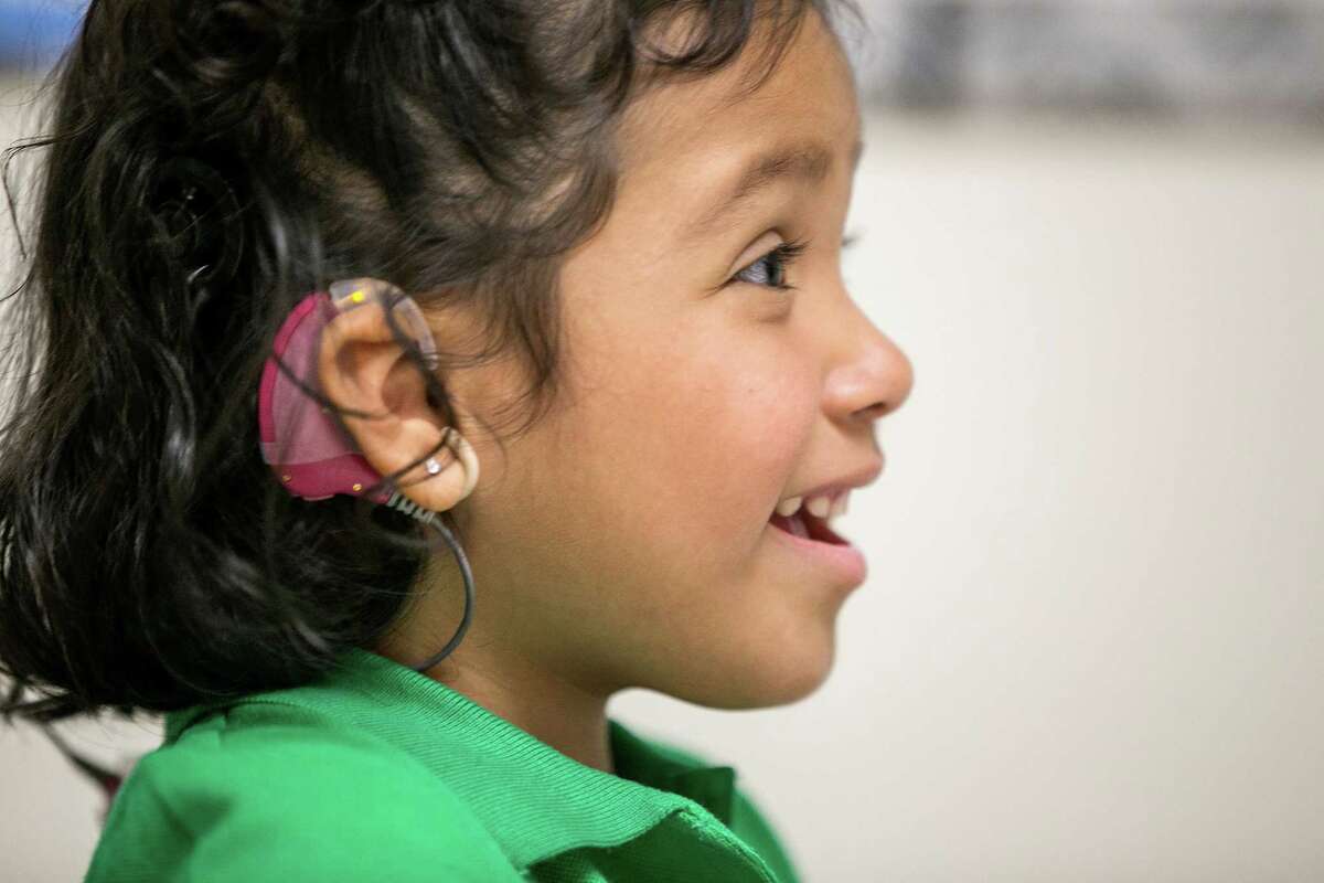 In this Feb. 11, 2015 photo, Angelica Lopez, 3, smiles during a therapy session at the University of Southern California in Los Angeles. Angelica was born deaf and received an auditory brainstem implant to allow her to hear some sounds in a research study at the USC.