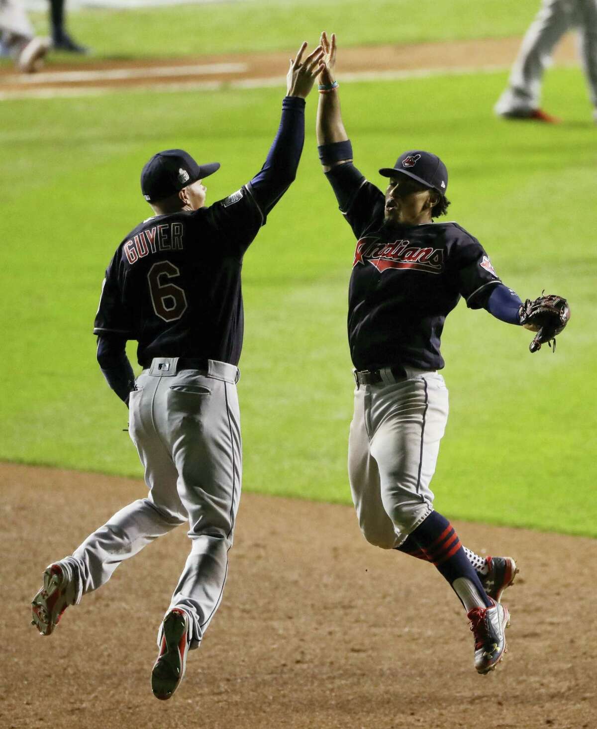 Cleveland Indians shortstop Francisco Lindor, right, and left fielder Brandon Guyer celebrate after their win in Game 3 on Friday.