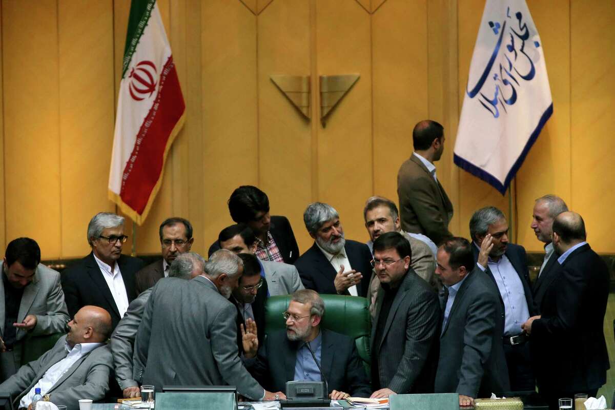 In this photo taken on Sunday, Oct. 11, 2015, Iran’s parliament speaker Ali Larijani, center, speaks with lawmakers in an open session of parliament while discussing a bill on Iran’s nuclear deal with world powers, in Tehran, Iran. Iran’s parliament voted Tuesday to support implementing a landmark nuclear deal struck with world powers despite hard-line attempts to derail the bill, suggesting the historic accord will be carried out.