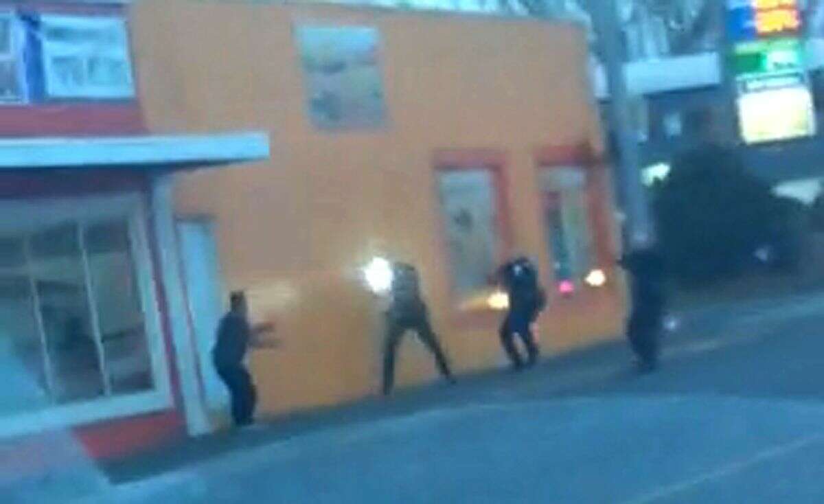 In this still frame taken from a cell phone video provided by Dario Infante and taken on Feb. 10, 2015, Antonio Zambrano-Montes, left, turns to face police officers as one holds a flashlight and two others draw their guns just before shooting him in Pasco, Wash. Pasco police said Zambrano-Montes threw multiple rocks, hitting two officers, and refused to put down other stones, and witnesses said he was running away when officers shot and killed him. (AP Photo/Dario Infante)