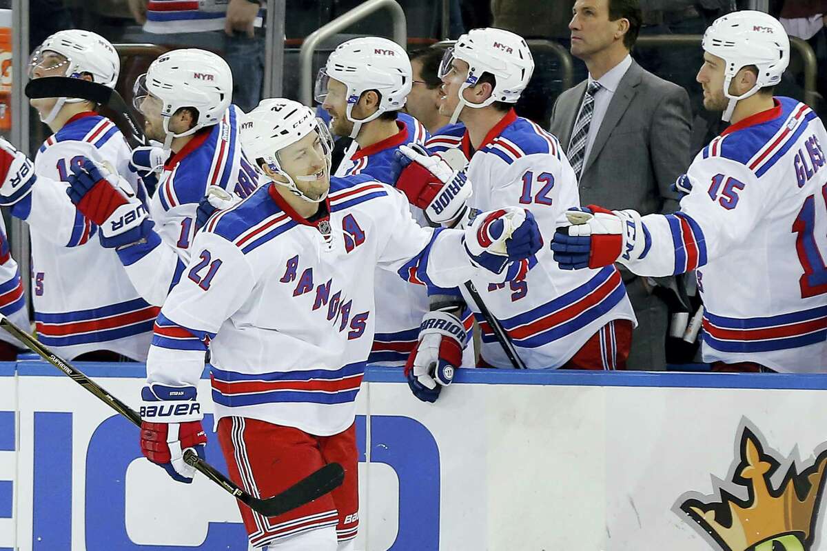 New York Rangers center Derek Stepan (21) is congratulated by teammates after scoring against the Philadelphia Flyers during the third period Sunday. Stepan scored his 100th and 101st career goals.
