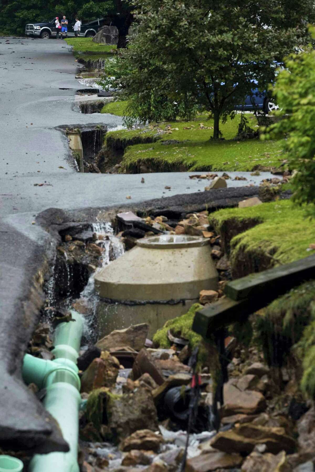 Exposed piping of city water and sewers systems lay bare after being exposed by the removal of front lawns and large portions of asphalt along Oakford Avenue by severe flood waters in Richwood, W.Va. on Friday.