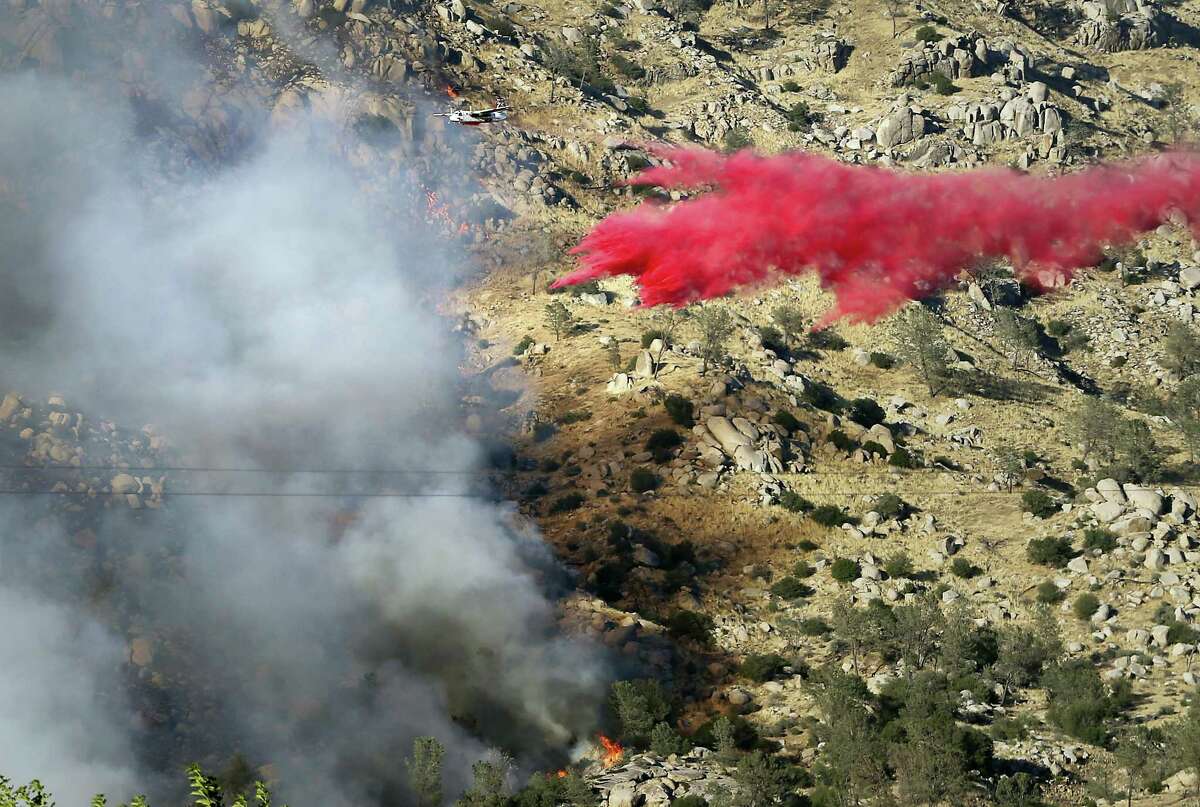 An air tanker makes a fire retardant drop on the southwest flank of the Erskine Fire near Lake Isabella, Calif., Thursday, June 23, 2016, and is moving towards Onyx.
