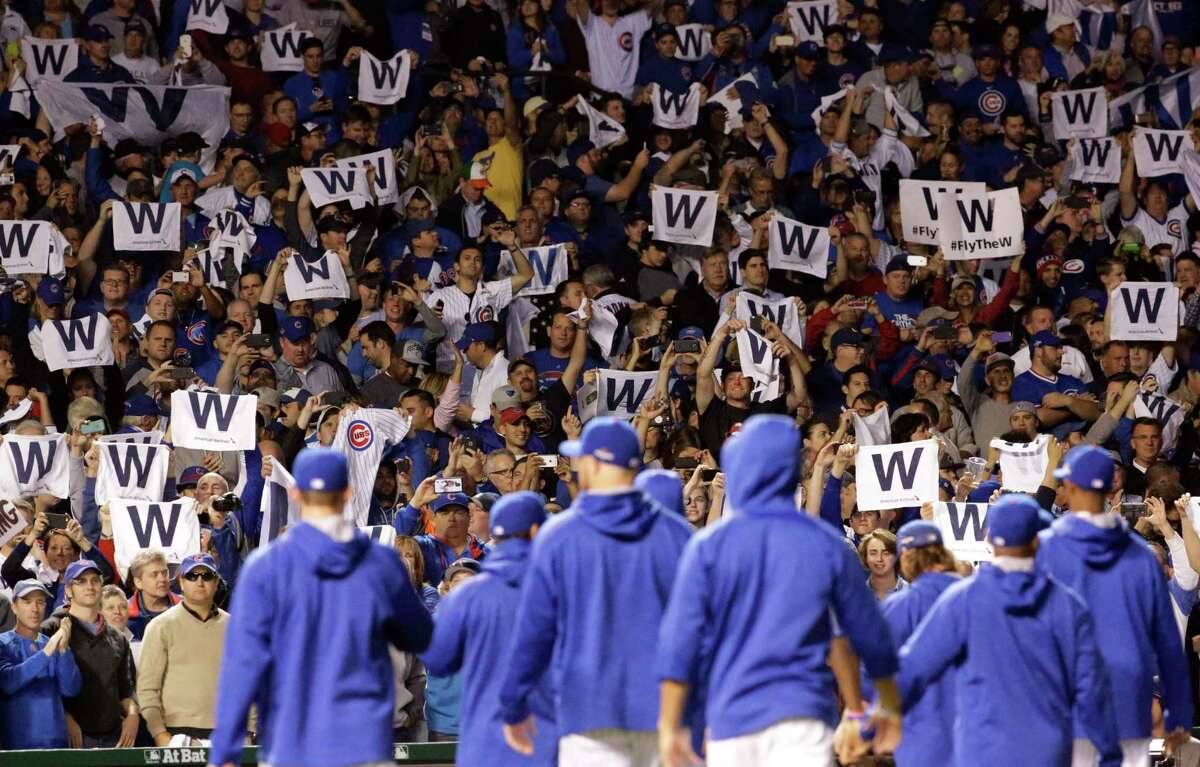 Chicago Cubs fans cheer after Game 3 of the National League Division Series Monday in Chicago.