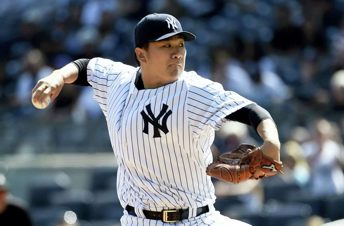 FILE - In this Sept. 13, 2015, file photo, New York Yankees starter Masahiro Tanaka pitches in the first inning of a baseball game against the Toronto Blue Jays in New York. Tanaka, coming back after arthroscopic surgery to remove a bone spur from his right elbow last October, says he feels perfectly healthy but is not sure when he will make his first regular-season start. (AP Photo/Kathy Kmonicek, File)
